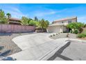 Exterior of a two-story home with a tile roof, a two-car garage, and low-maintenance landscaping at 10554 Lilac Tree Ave, Las Vegas, NV 89135