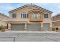 Exterior shot of the townhome shows the attached two-car garage and private balcony at 1150 Red Margin Ct # 101, Las Vegas, NV 89183