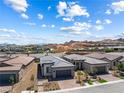 Expansive aerial shot of a neighborhood with mountain views in the distance at 171 Palm Fox Ct, Henderson, NV 89011