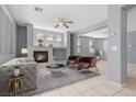 Bright living room featuring a fireplace, neutral tones, modern furniture, and tile flooring at 180 Duck Hollow Ave, Las Vegas, NV 89148