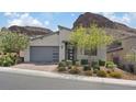 Contemporary home with well-kept landscaping, and a modern garage door design at 1957 Regal Bluff Dr, Henderson, NV 89052