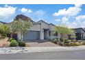 Beautiful single-story home with modern design, desert landscaping, and attached garage at 1957 Regal Bluff Dr, Henderson, NV 89052