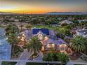 Stunning aerial view of the home with solar panels, lush landscaping, and a beautiful city skyline at 2086 Troon Dr, Henderson, NV 89074