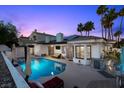 Backyard pool area with patio, outdoor grill, mature landscaping, and outdoor seating, perfect for entertaining at 219 Windsong Dr, Henderson, NV 89074