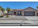 Charming single-story home with a two-car garage, mature landscaping, and a tile roof at 2711 Briarcliff Ave, Henderson, NV 89074