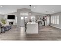 Open-concept kitchen with a large center island, stainless steel appliances, and hardwood floors at 2711 Briarcliff Ave, Henderson, NV 89074