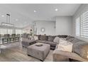Bright living room featuring a comfortable sectional sofa, wood floors, and recessed lighting at 2711 Briarcliff Ave, Henderson, NV 89074