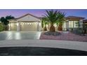 Well-maintained single-story home with a three-car garage, desert landscaping, and palm trees at 2873 Knoxville Ct, Henderson, NV 89052