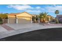 Well-maintained single-story home with a three-car garage, desert landscaping, and palm trees at 2873 Knoxville Ct, Henderson, NV 89052