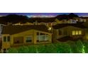 Nighttime view of homes in a neighborhood against a skyline, highlighting community living and city proximity at 3 Hilltop Crest St, Henderson, NV 89011