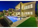 Inviting backyard oasis with a sparkling pool, ample seating, and lush landscaping for ultimate outdoor enjoyment at 3 Hilltop Crest St, Henderson, NV 89011