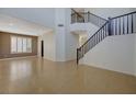 Inviting foyer featuring a staircase and an abundance of natural light from the windows at 3034 Scenic Valley Way, Henderson, NV 89052