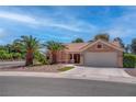 Beautiful single-story home with desert landscaping, large palm trees, and a two-car garage at 3040 Hidden Treasure Dr, Las Vegas, NV 89134