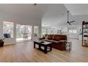 Bright, spacious living room featuring hardwood floors, modern ceiling fan, and backyard access at 3040 Hidden Treasure Dr, Las Vegas, NV 89134