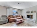 Inviting living room featuring a cozy fireplace and a comfortable seating area near bright window at 3382 Berwyck St, Las Vegas, NV 89121