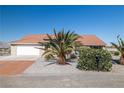 Charming single-story home featuring desert landscaping, a spacious driveway, and an attached two-car garage at 3430 Flagstone Ct, Pahrump, NV 89048