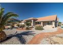Charming single-story home featuring desert landscaping, a spacious driveway, and a tiled roof at 3430 Flagstone Ct, Pahrump, NV 89048