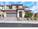 Two-story home with desert landscaping, tile roof, and a two car garage on a sunny day at 3512 Portiani Dr, Las Vegas, NV 89141