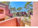 View of a multi-story building with attractive landscaping and a well-maintained exterior at 4050 Pacific Harbors Dr # 245, Las Vegas, NV 89121