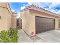 Home featuring a two-car garage, gated entry, and desert landscaping at 4437 Alto Verde Dr, Las Vegas, NV 89119