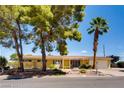 Attractive single-story house with mature landscaping, and a well-maintained front yard at 502 E Fairway Rd, Henderson, NV 89015