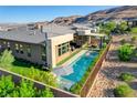 A sprawling backyard showcasing a pool, spa, patio, and manicured landscaping at 5155 Rock Daisy Dr, Las Vegas, NV 89135