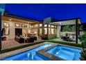 An inviting backyard with a pool, spa, and an outdoor kitchen, perfect for entertaining at 5155 Rock Daisy Dr, Las Vegas, NV 89135