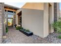 A contemporary home's front entryway with stone accents and modern landscaping at 5155 Rock Daisy Dr, Las Vegas, NV 89135