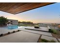 Outdoor oasis featuring a pool, spa, fire pit, barbecue, and panoramic mountain views at 6 Rock Mount Ct, Henderson, NV 89012