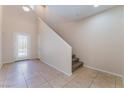 Bright entryway with tile flooring, stairs leading to the second floor, and a door with glass panes at 6125 Paddleboat St, North Las Vegas, NV 89031