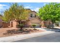 Attractive two-story home with a front-facing two-car garage and low-maintenance landscaping at 6125 Paddleboat St, North Las Vegas, NV 89031