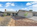 Inviting single-story home with well-manicured desert landscaping and a cozy front porch at 6791 Greengrove Dr, Las Vegas, NV 89103