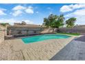 Refreshing backyard pool with surrounding patio, perfect for relaxation and entertaining at 6791 Greengrove Dr, Las Vegas, NV 89103