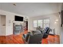Relaxing living room boasts hardwood floors, a fireplace, and ample natural light from large windows at 689 Bay View Dr # 1311, Boulder City, NV 89005