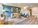 Open-concept living room with modern decor, plush seating, stylish accents, and staircase leading to upper level at 6928 Wrightshire St # 19, Las Vegas, NV 89166