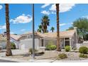 Charming single-story home features a well-manicured front yard, a two-car garage, and a classic stucco facade at 6997 Ray Charles Ln, Las Vegas, NV 89119
