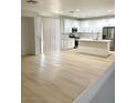 Open-concept kitchen featuring modern white cabinets, stainless steel appliances, and a center island at 7615 Paso Robles Ave, Las Vegas, NV 89113