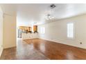 Open living space with hardwood flooring, plantation shutters, and seamless transition into adjacent kitchen at 7923 Homer Ct, Las Vegas, NV 89139