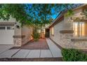 Inviting entryway featuring stone accents, a walkway, and a well-manicured garden leading to the front door at 8128 Devils Canyon St, North Las Vegas, NV 89085