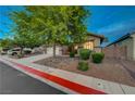Well-maintained single-story home with a two-car garage, landscaped front yard, and inviting curb appeal at 8128 Devils Canyon St, North Las Vegas, NV 89085