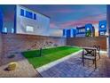 Enclosed backyard space featuring low-maintenance turf, desert landscaping, and a stylish seating area at 8178 Eaton Hill St, Las Vegas, NV 89113