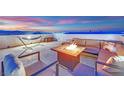 Relaxing rooftop deck with comfortable seating, a fire pit, and city views; perfect for outdoor entertaining at 8178 Eaton Hill St, Las Vegas, NV 89113