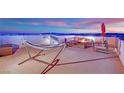 Rooftop deck featuring comfortable seating, fire pit, and stunning city views at 8178 Eaton Hill St, Las Vegas, NV 89113