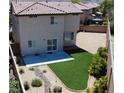 A private backyard, featuring artificial turf, a patio, and low-maintenance landscaping at 8682 Gateway Glen Dr, Las Vegas, NV 89178