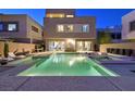 Backyard pool with lush landscaping, lounge chairs, outdoor dining, and a relaxing spa at 881 Barrhead Ave, Henderson, NV 89012