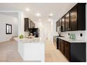 Stylish kitchen featuring granite countertops, stainless steel appliances, and dark wood cabinetry with modern fixtures at 9545 Parker Springs Ct, Las Vegas, NV 89166