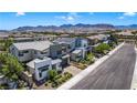An aerial view of a contemporary home showcases its modern architecture and is nestled in a neighborhood near desert mountains at 10297 Sierra Skye Ave, Las Vegas, NV 89166