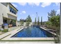 A pristine pool provides a refreshing oasis in this backyard, complemented by lush greenery and lounge area at 10297 Sierra Skye Ave, Las Vegas, NV 89166