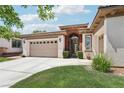 Beautiful home with a spacious driveway and wrought-iron gate leading to a cozy front courtyard at 10404 Stanberry Ave, Las Vegas, NV 89135