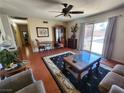 Comfortable living room featuring tile flooring, ceiling fan, and sliding glass doors to the backyard at 109 Prince Ln, Las Vegas, NV 89110